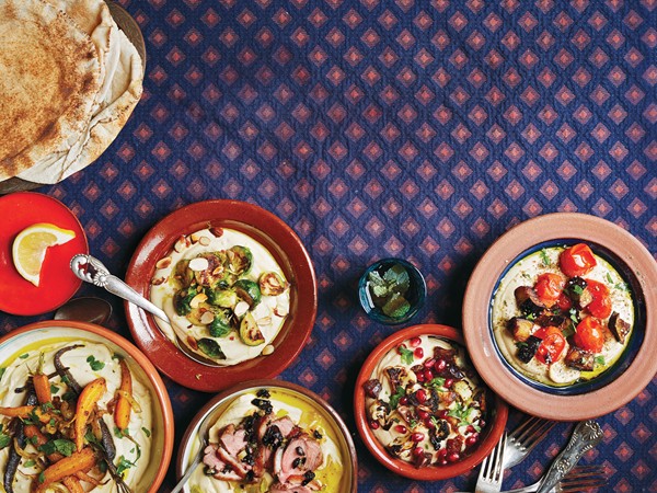 Hummus with pan-seared duck, leeks, and tapenade