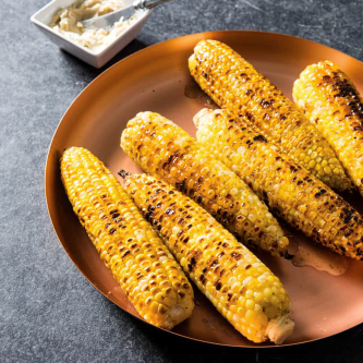 Husk-grilled corn with seasoned butter