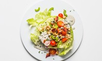 Iceberg salad with blue cheese, tomatoes, and bacon