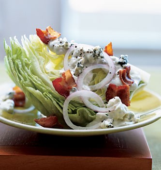 Iceberg wedge salad with warm bacon and blue cheese dressing