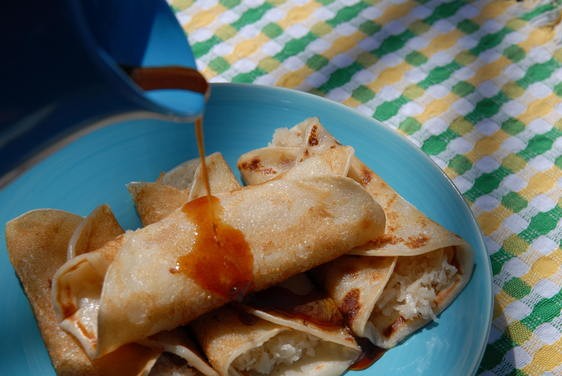 Indian crepe with cardamom coconut filling, drizzled with date syrup (Patishapta)