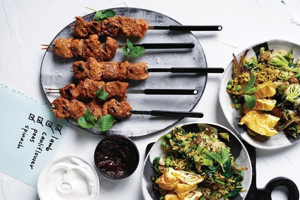 Indian vegetable fried rice with tandoori lamb skewers