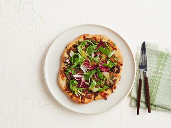 Individual mushroom pizzas with arugula