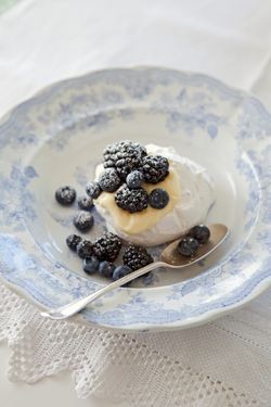 Individual Pavlovas with lemon cream and dark berries