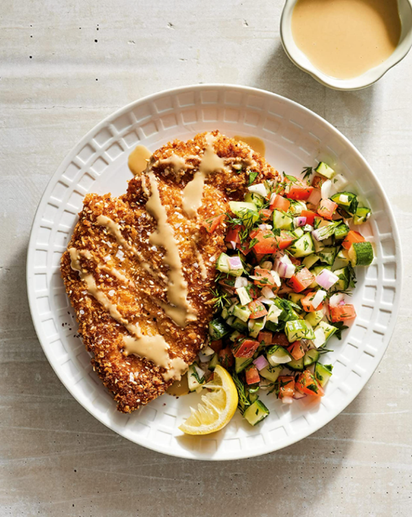 Israeli-style sesame schnitzel with herby tomato cucumber salad