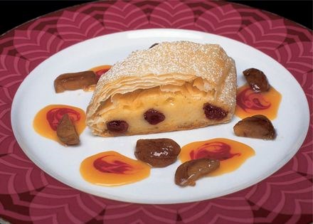 Italian cranberry cheesecake strudel with candied chestnuts and caramel sauce