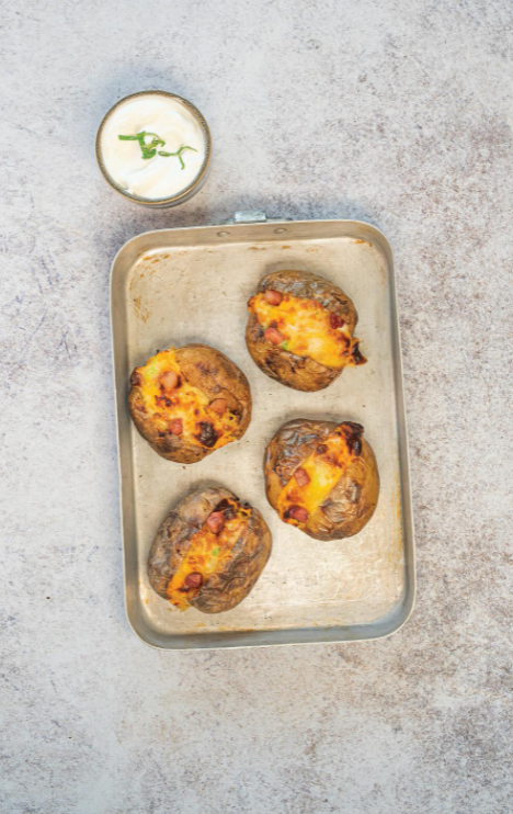 Jacket potatoes with cheese, sour cream, scallions, and crispy bacon