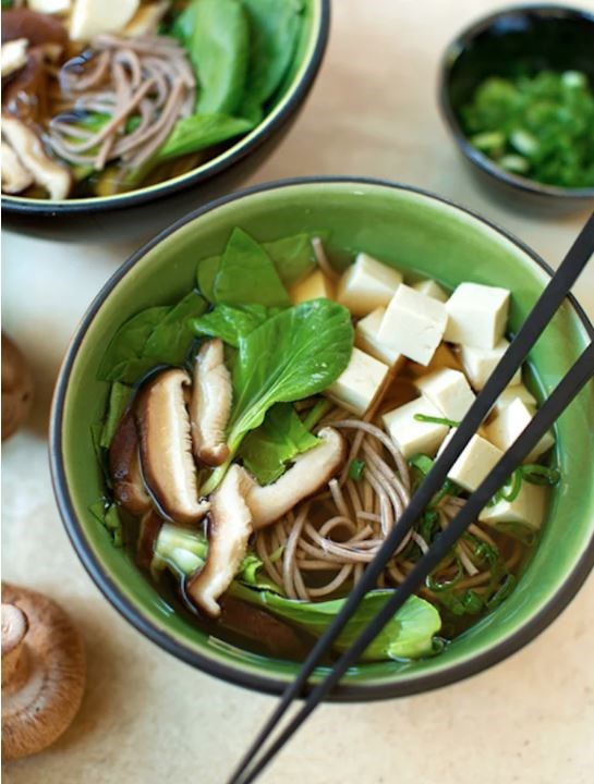 Japanese soba noodle soup with tofu and spring greens