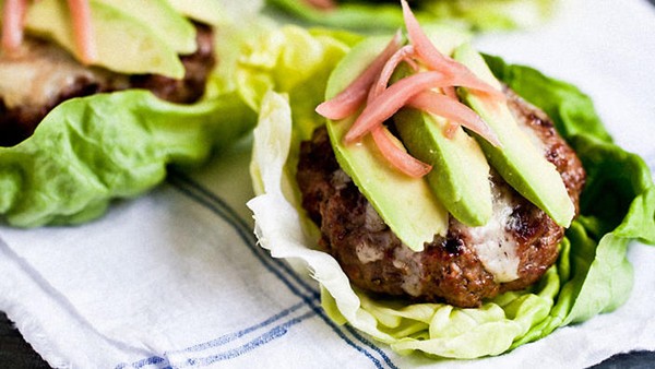 Juicy burgers with Gruyère, avocado, and pickled onions, tucked into butter lettuce "buns"