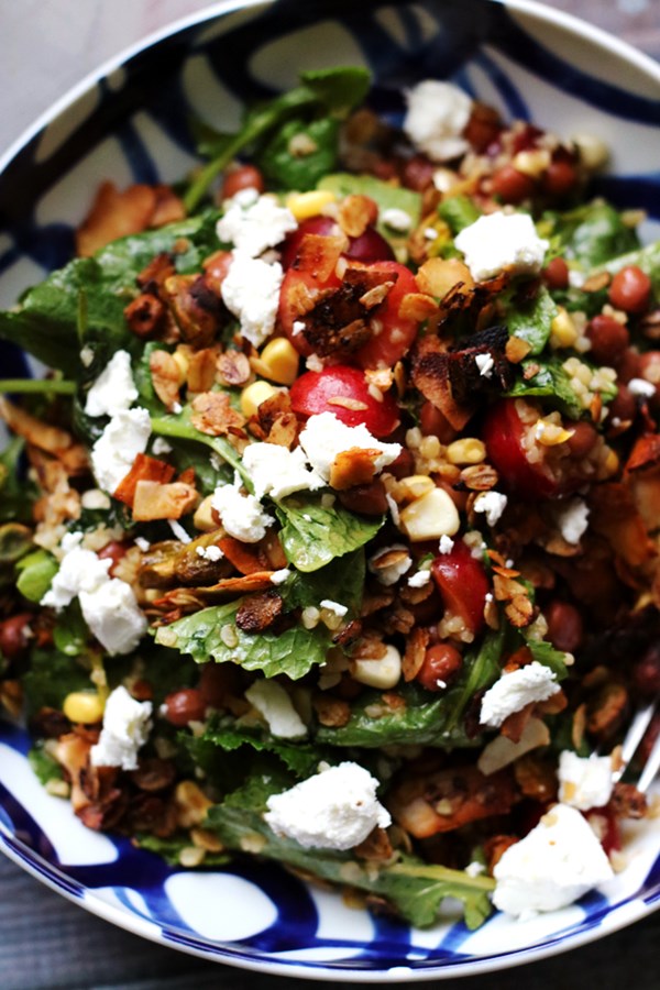 Kale, cherry, and bulgur salad with savory pistachio granola and goat cheese