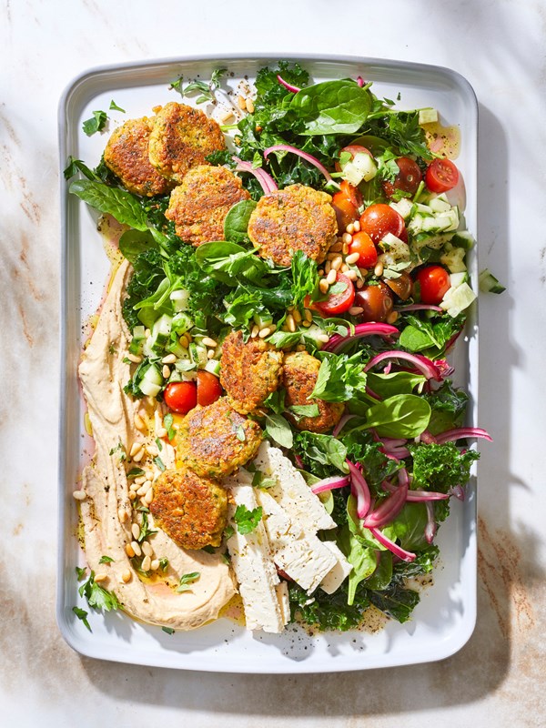 Kale falafel salad with toasted pine nuts and hummus