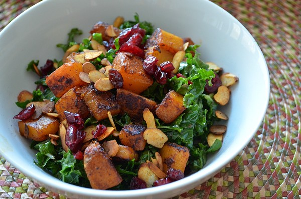 Kale salad with butternut squash, dried cranberries & pepitas with spicy, smoky balsamic vinaigrette