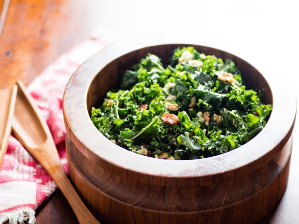 Kale salad with oven-dried grapes, toasted walnuts, and blue cheese