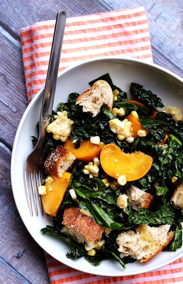 Kale salad with peaches, corn, and basil-honey vinaigrette