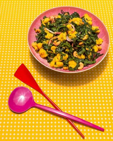 Kale salad with turmeric cauliflower, spiced cashews and pumpkin seds