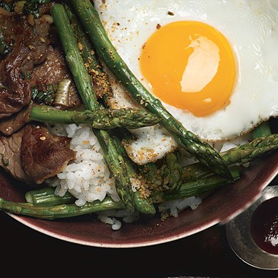 Korean rice bowl with steak, asparagus, and fried egg