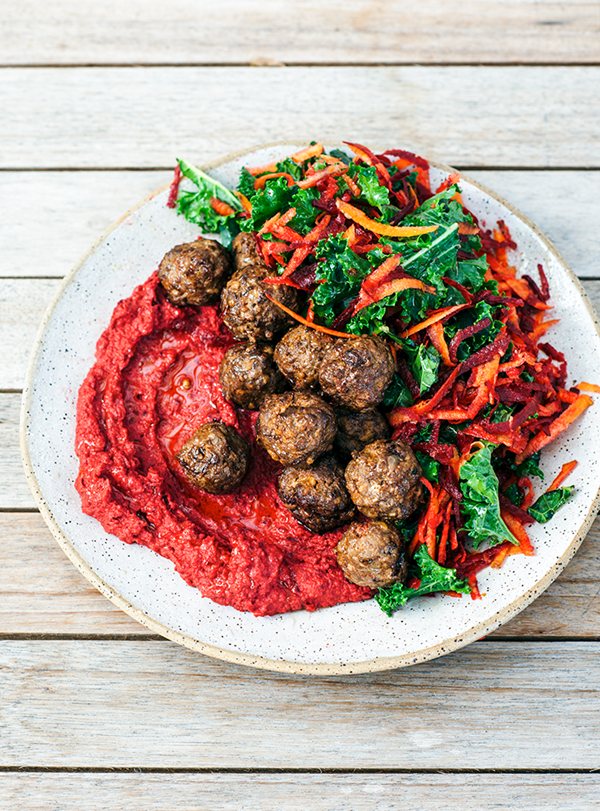 Lamb balls on a bed of kale, beetroot and carrot salad with beetroot hummus