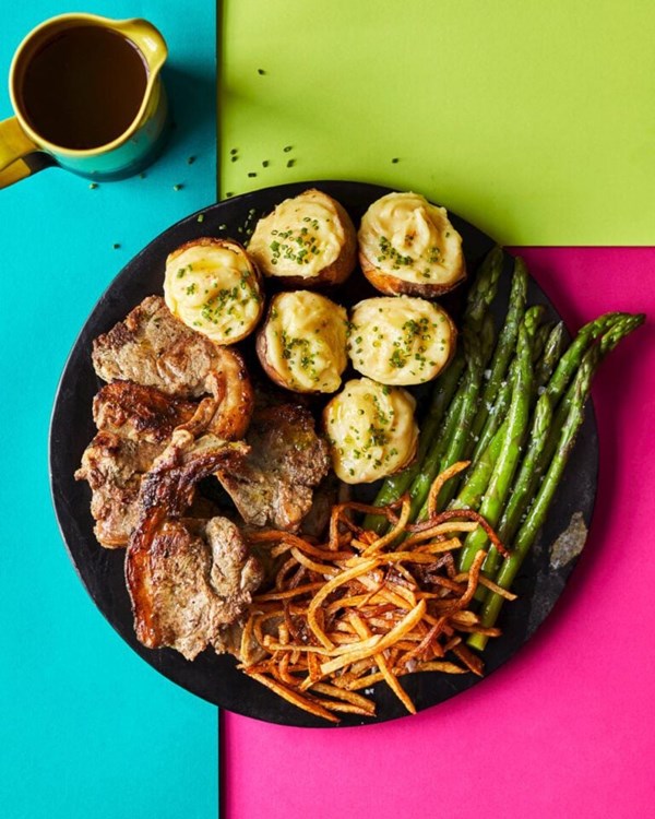 Lamb chop platter with cheesy potato skins, crispy bits and asparagus 