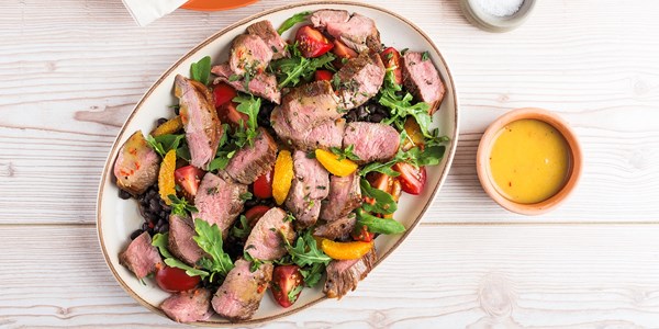 Lamb leg steak salad, tomato and black beans with chilli and orange dressing