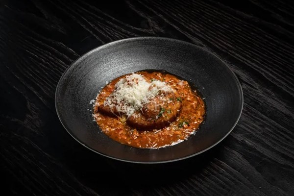 Lamb ragù and fried potato dumplings with Le Gruyère AOP filling