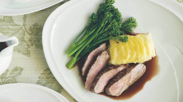 Lamb rump with gravy, layered potatoes and broccolini