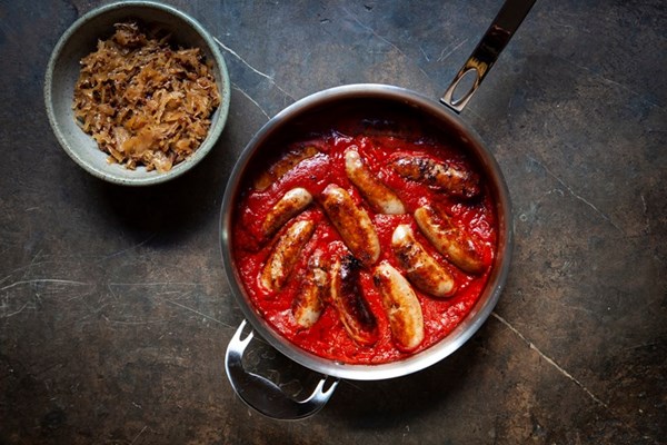Lamb sausages in tomato sauce with bacon sauerkraut