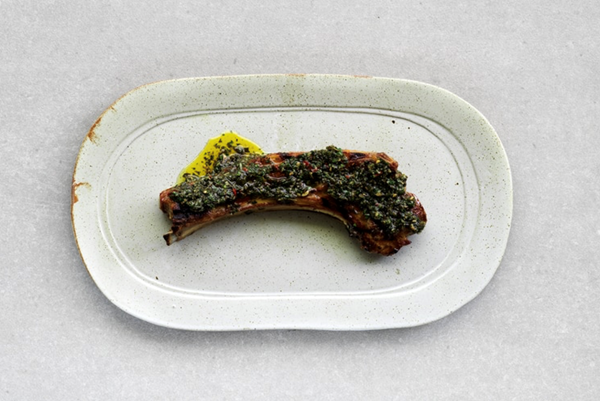 Lamb scottadito with cherry tomatoes, pecorino and fava