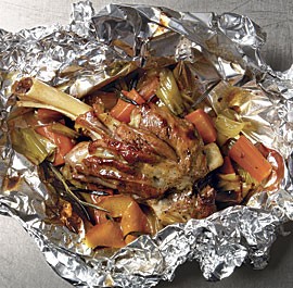 Lamb shanks en papillotes with leeks, carrots, rosemary, and orange