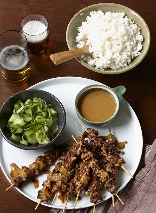 Lamb skewers with korma peanut sauce and cucumber salad