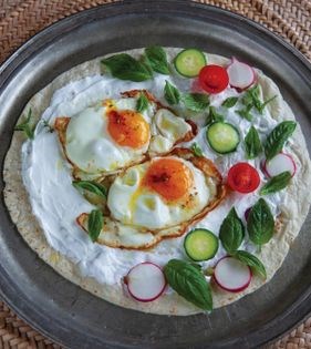 Lavash topped with garlicky yogurt + fried eggs (Guz lameh-ye Urmia)
