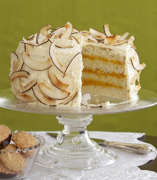 Layer cake with coconut and mango curd, coconut, and cream
