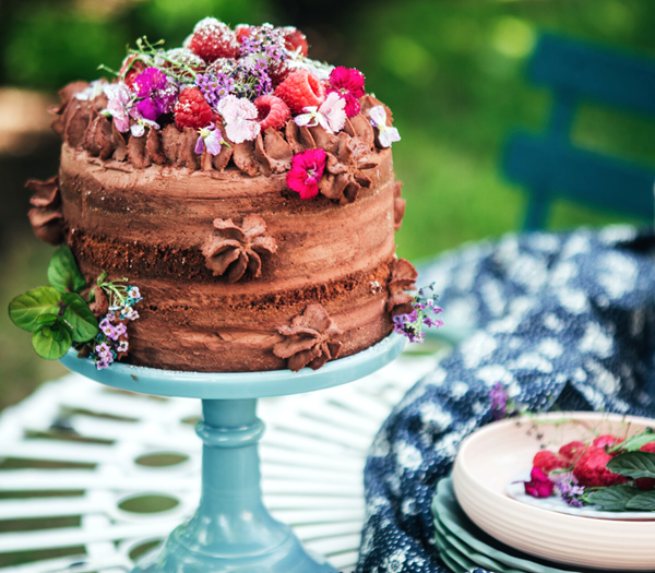 Layered chocolate nude cake with mascarpone cocoa frosting and raspberries