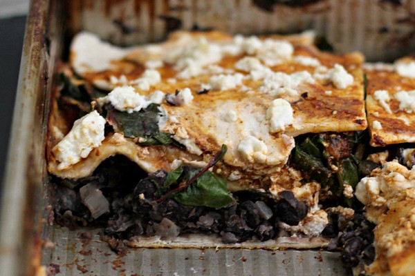 Layered pasilla-tortilla casserole with black beans, mushrooms, and chard