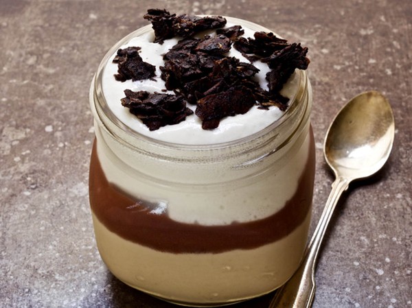 Layered toasted coconut puddings with red fruit puree and coconut cream