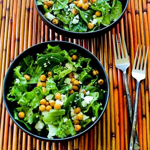 Leafy greens salad with roasted chickpeas, feta, and Mediterranean sumac dressing