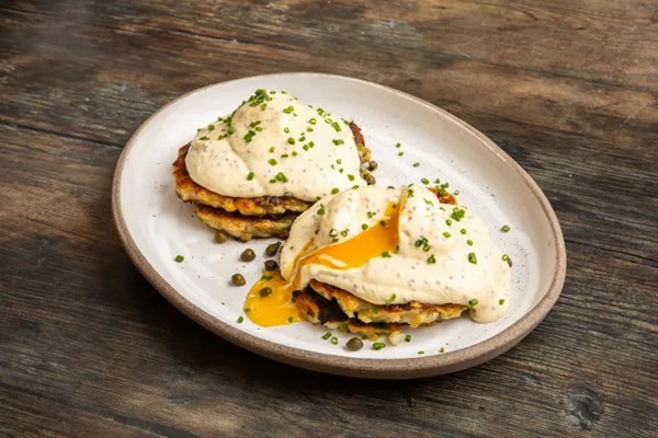 Leek and potato cakes with poached eggs and mustard sauce