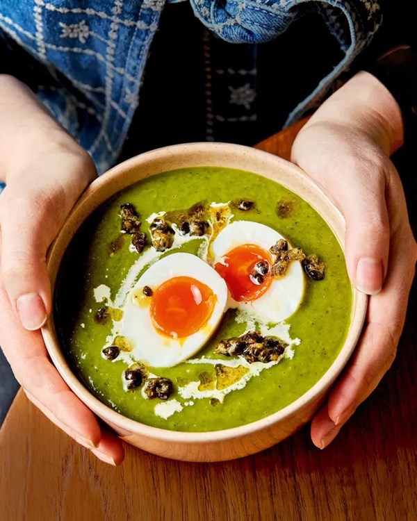 Leek and spring greens soup with soft eggs and crispy capers 