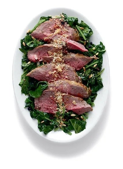 Leg of lamb with herb paste and spinach