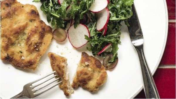 Lemon chicken cotoletta with radish, grape and rocket salad