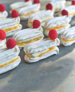 Lemon meringue éclairs with fresh cream & raspberries