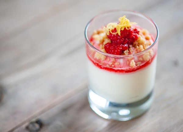 Lemon posset with raspberries and pine nuts