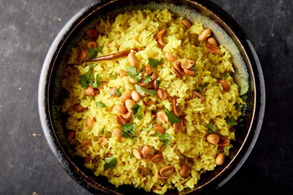 Lemon rice with fried peanuts and coconut