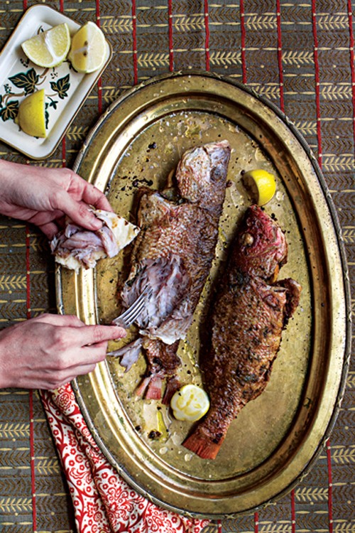 Lemon-stuffed fried fish with green chile rub (Samak imtabal maqli)