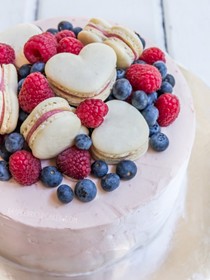 Lemon syrup sponge cake with whipped cream cheese icing and berries