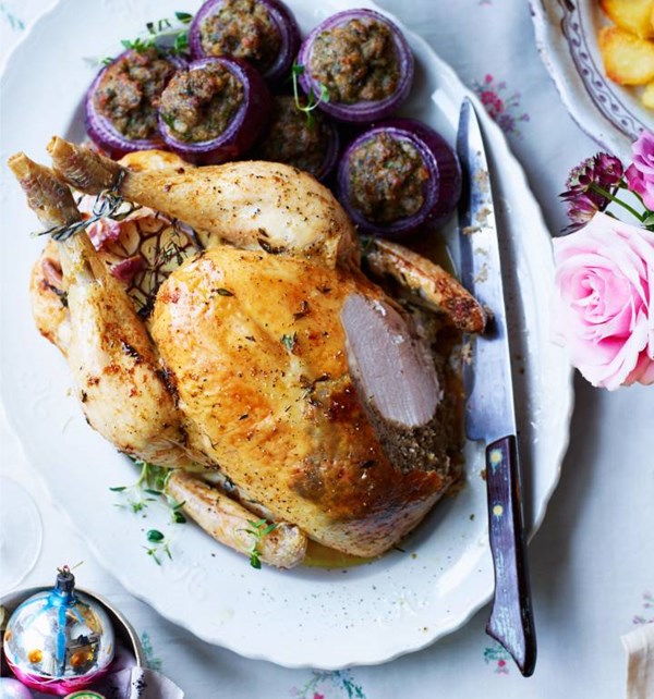 Lemon, thyme and garlic-roasted chicken with chestnut stuffing-filled red onions