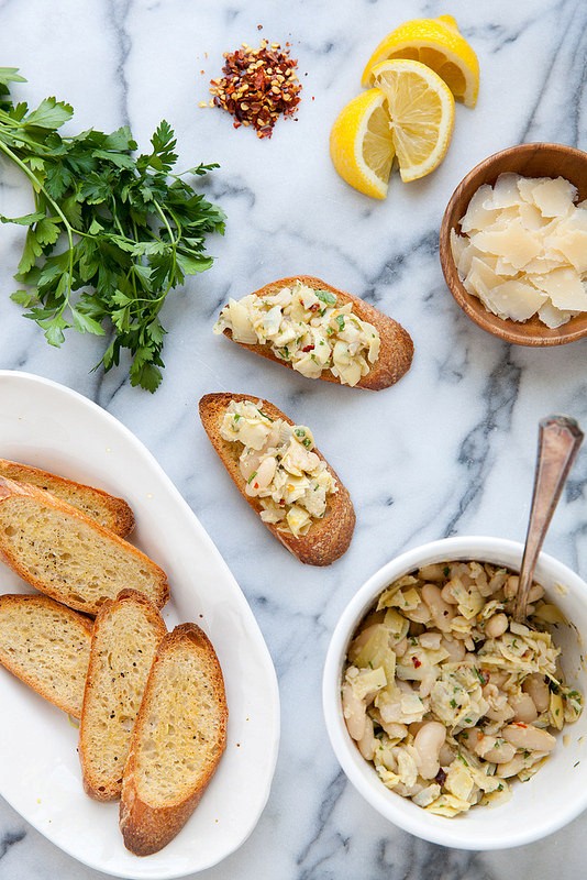Lemony artichoke white bean crostini with shaved Parmesan 
