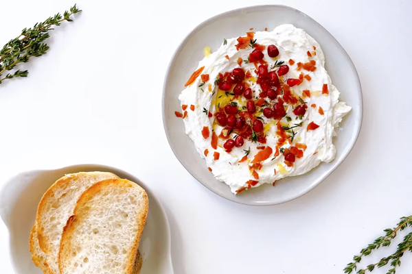 Lemony whipped goat cheese with crispy prosciutto & pomegranate