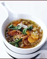 Lentil soup with serrano ham and arugula