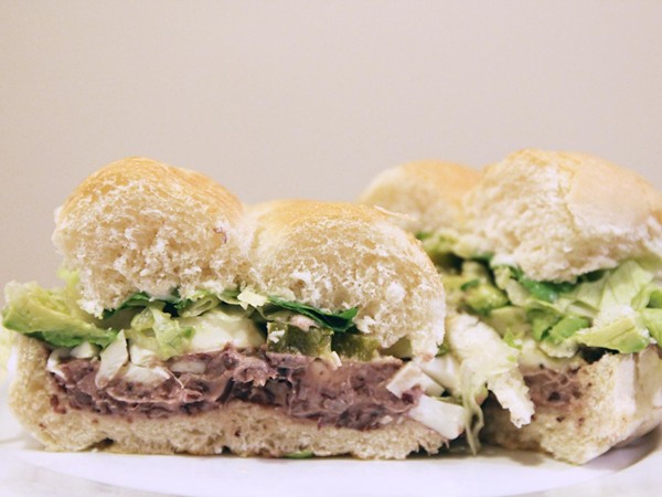 Loaded vegetarian tortas with avocados, queso oaxaca, black beans, and pickled jalapeño