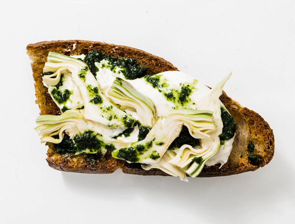 Local burrata toast with spring herb pesto and artichokes